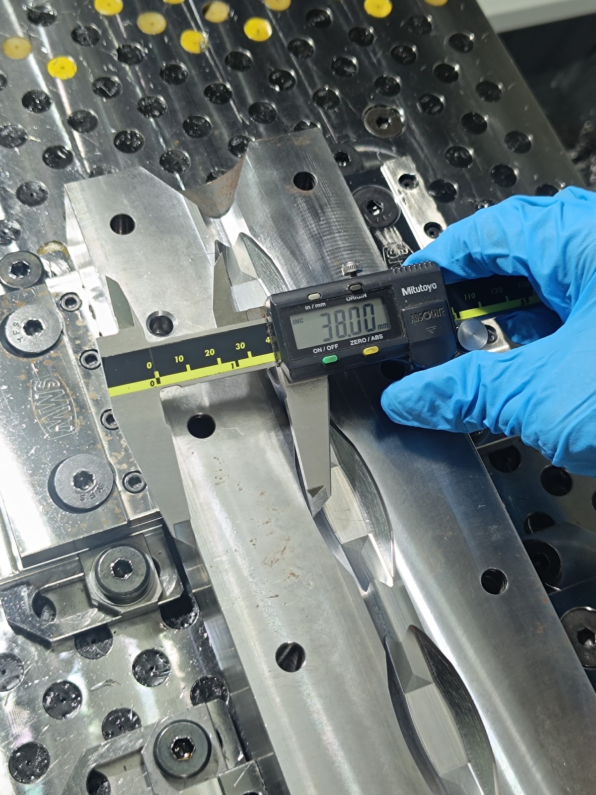 Quality inspection of a custom CNC machined part using a digital calliper